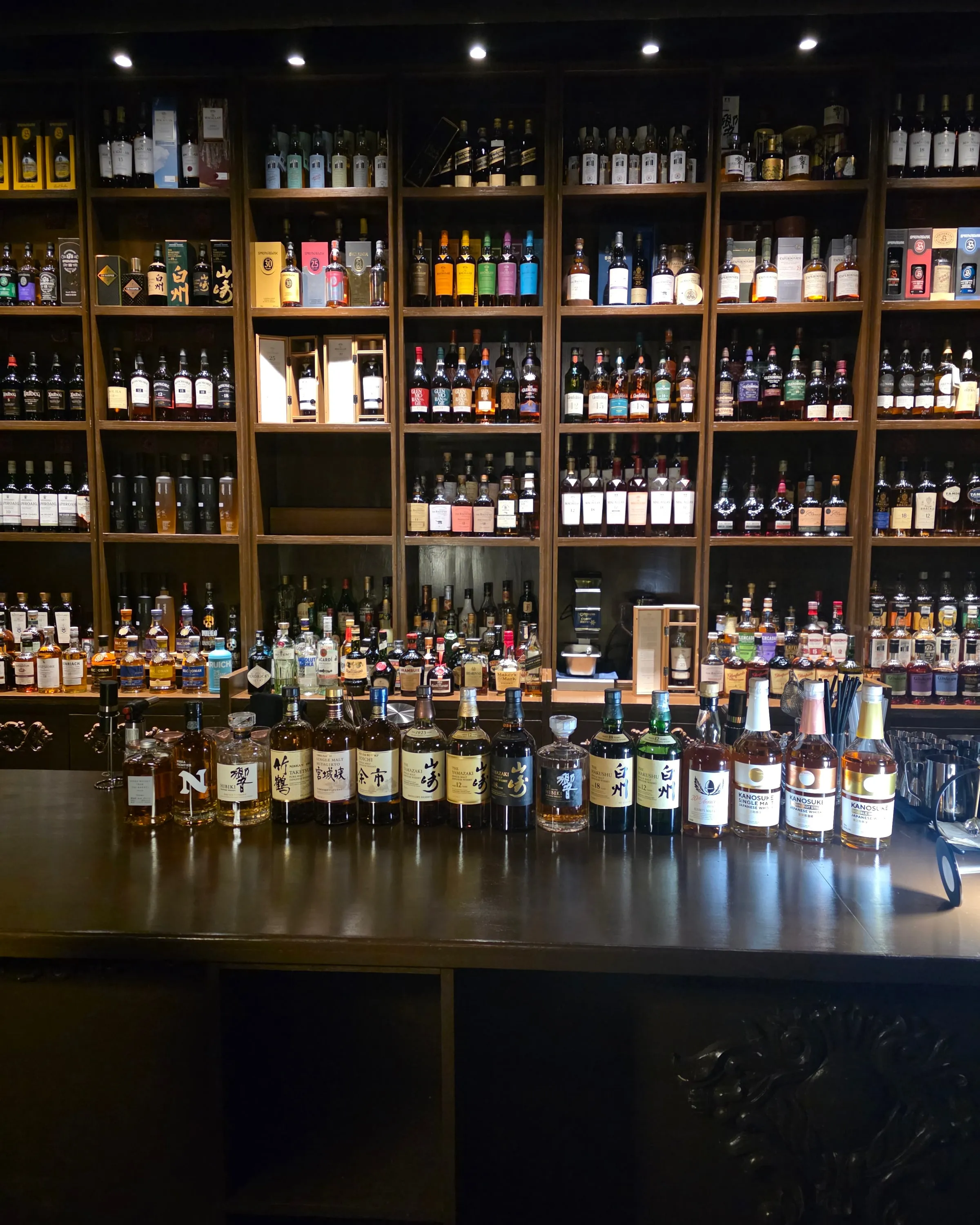 The bar counter and back bar at OAKDEN, a basement whisky lounge in Gwangju