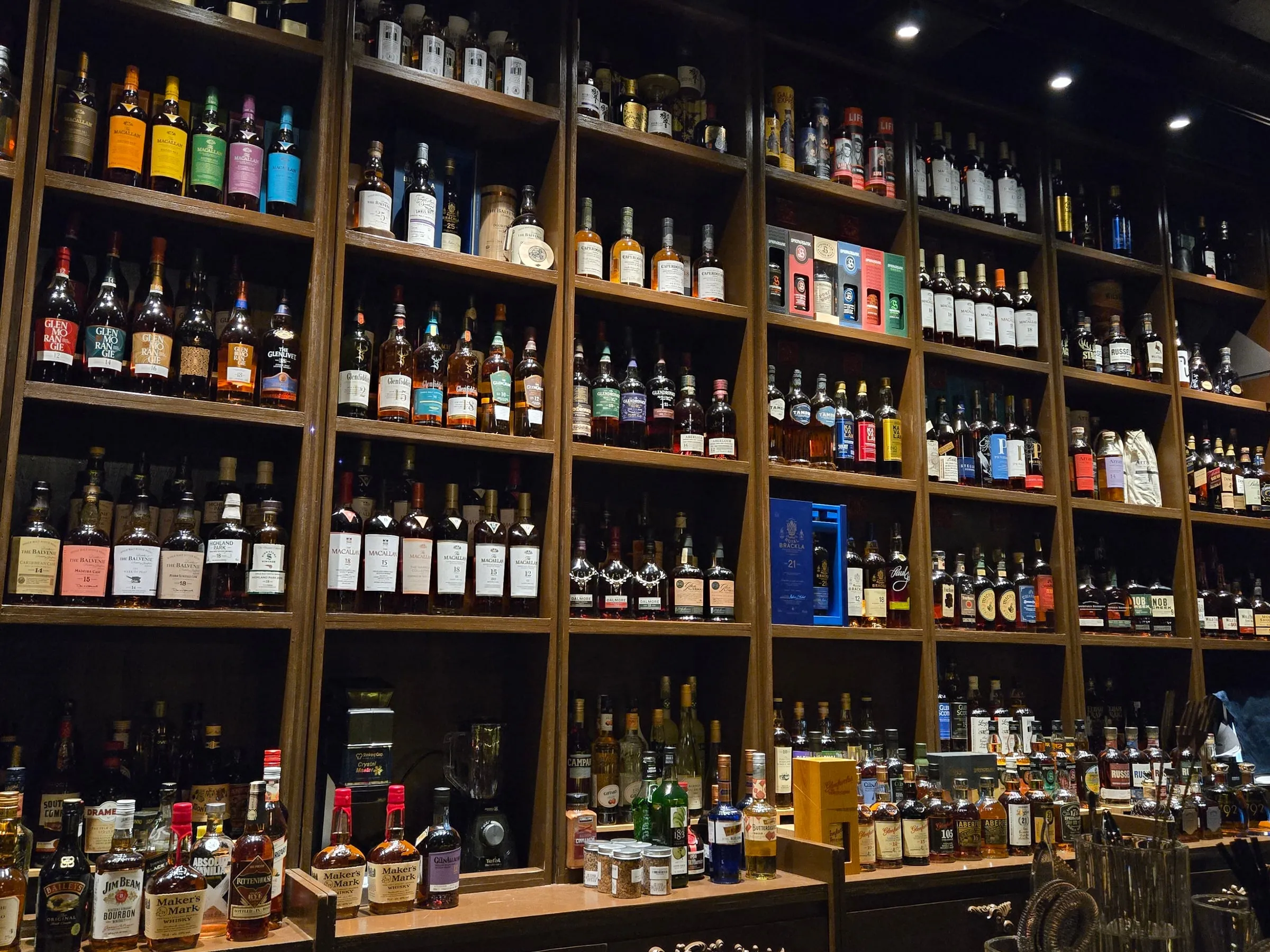Whisky bottles lined up on the back bar at OAKDEN